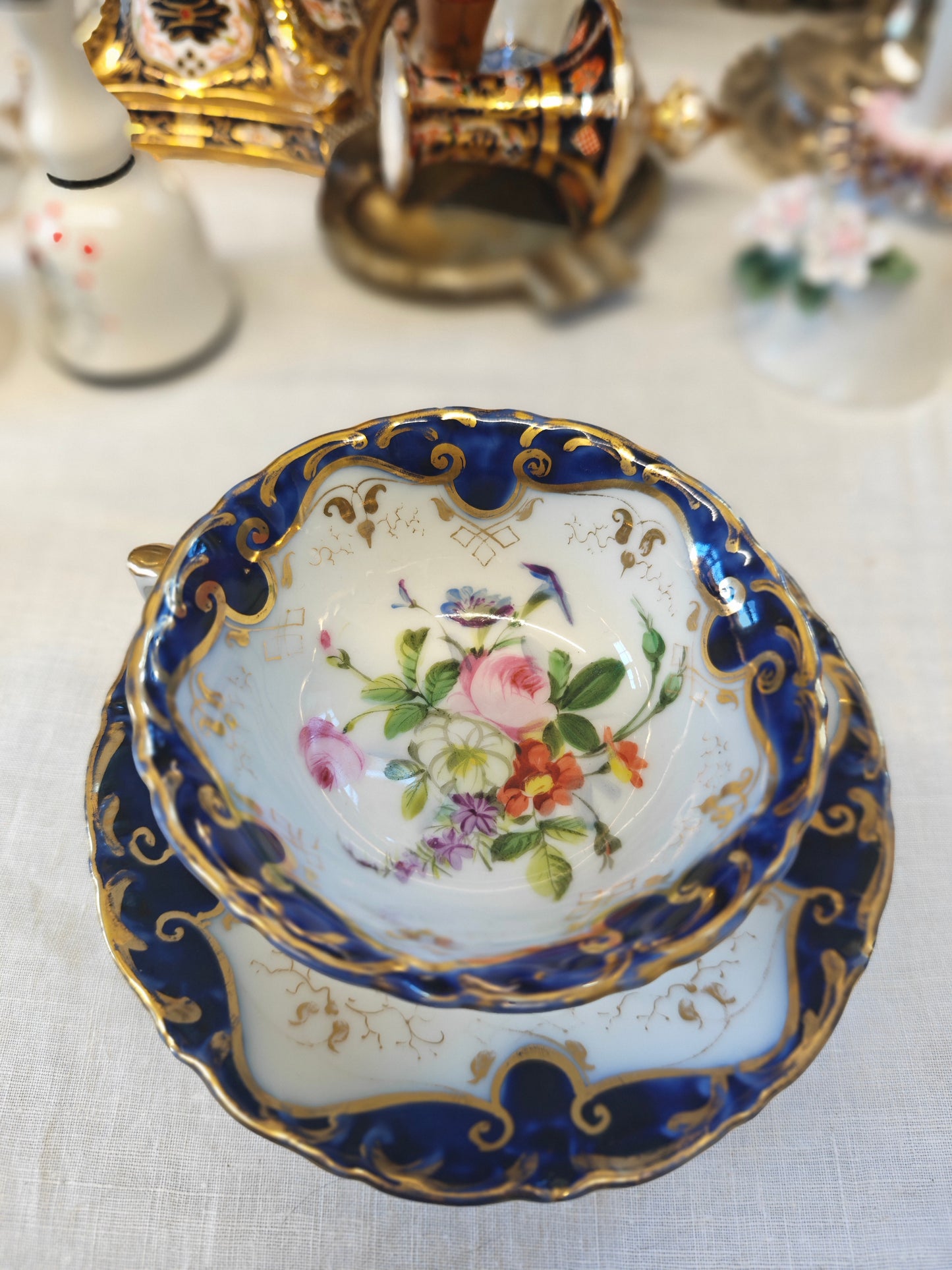 French Antique porcelain cup and saucer in rocaille style