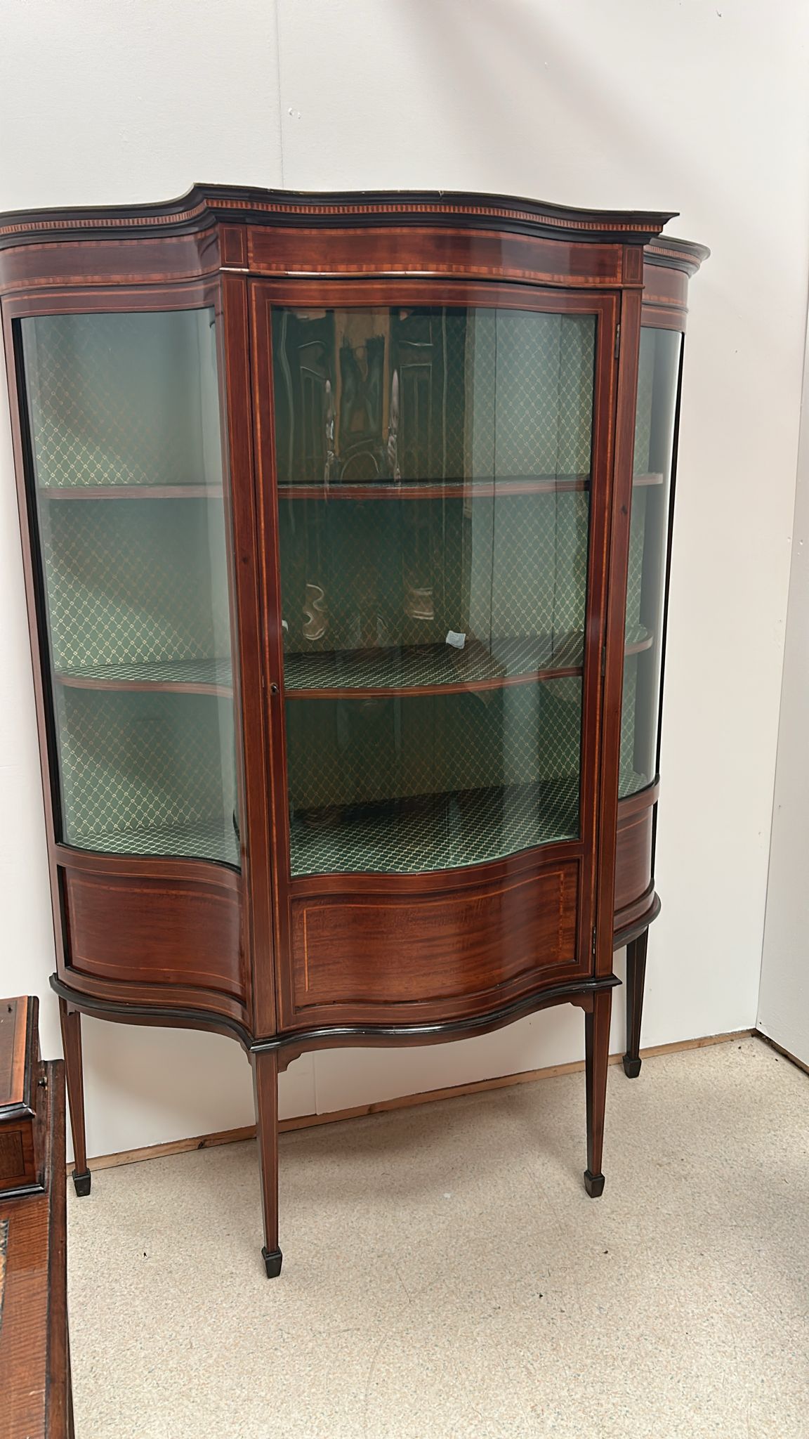 Edwardian Serpentine cabinet with full front glass