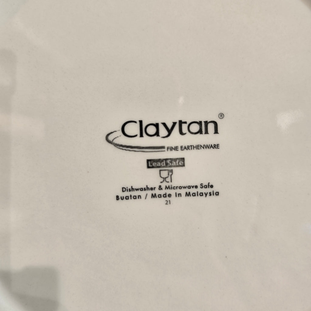 Claytan logo on a white ceramic plate