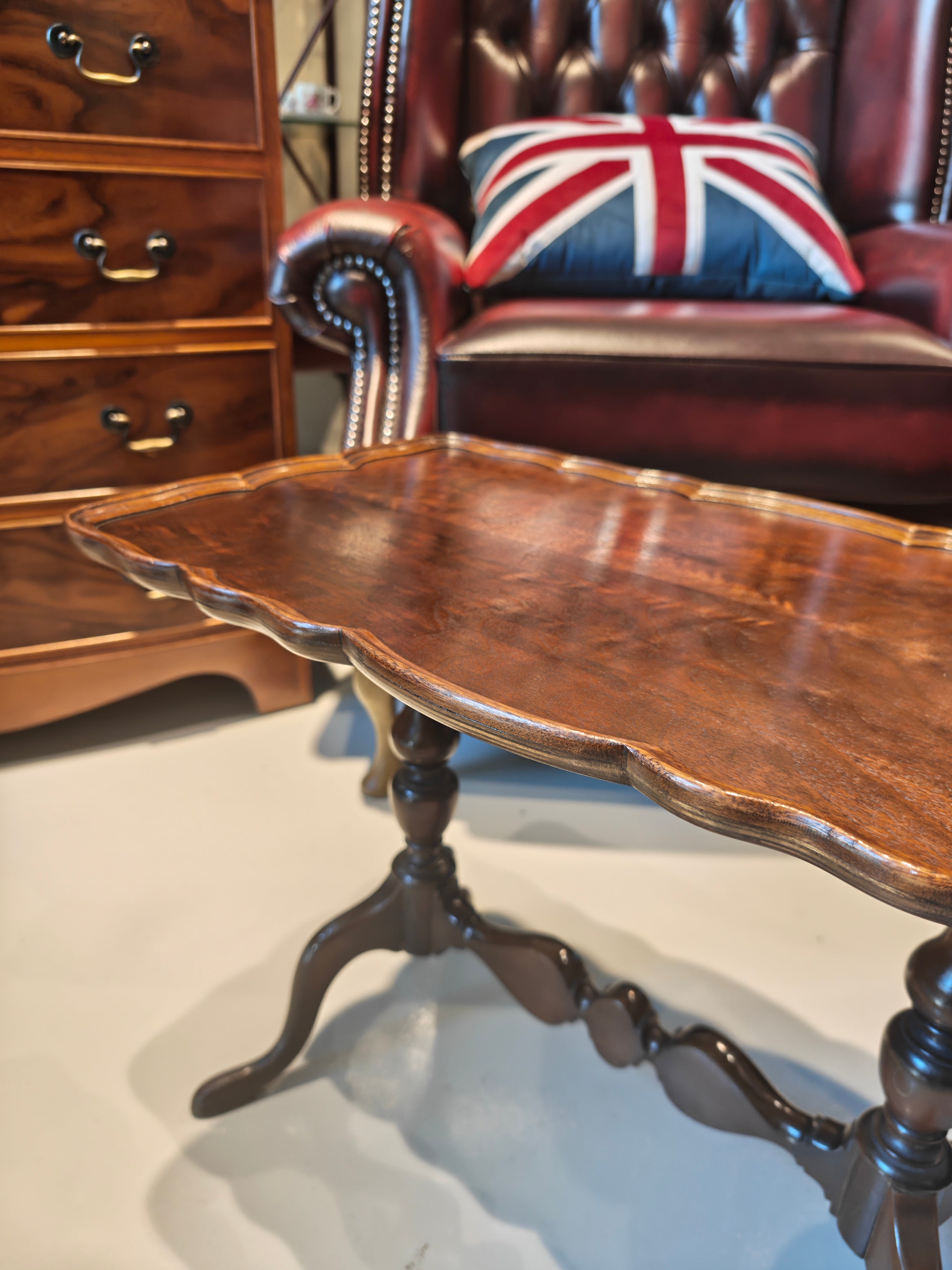 Antique mahogany table features a distinct pie-crust edge and a beautifully shaped stretchered base