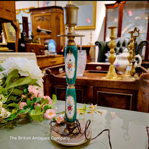 Decorative lamp on a table with a blurred background of an antique store.