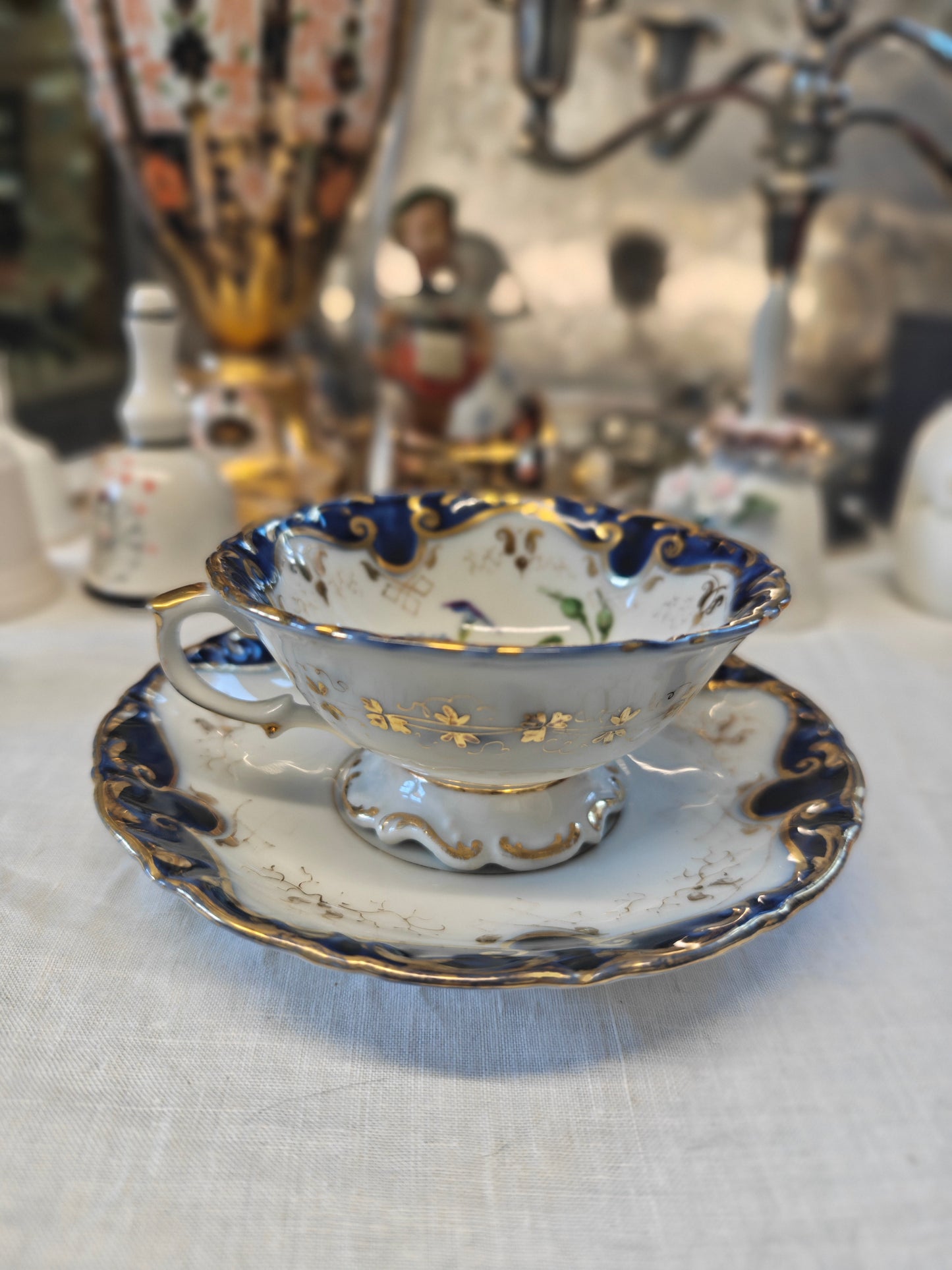 French Antique porcelain cup and saucer in rocaille style