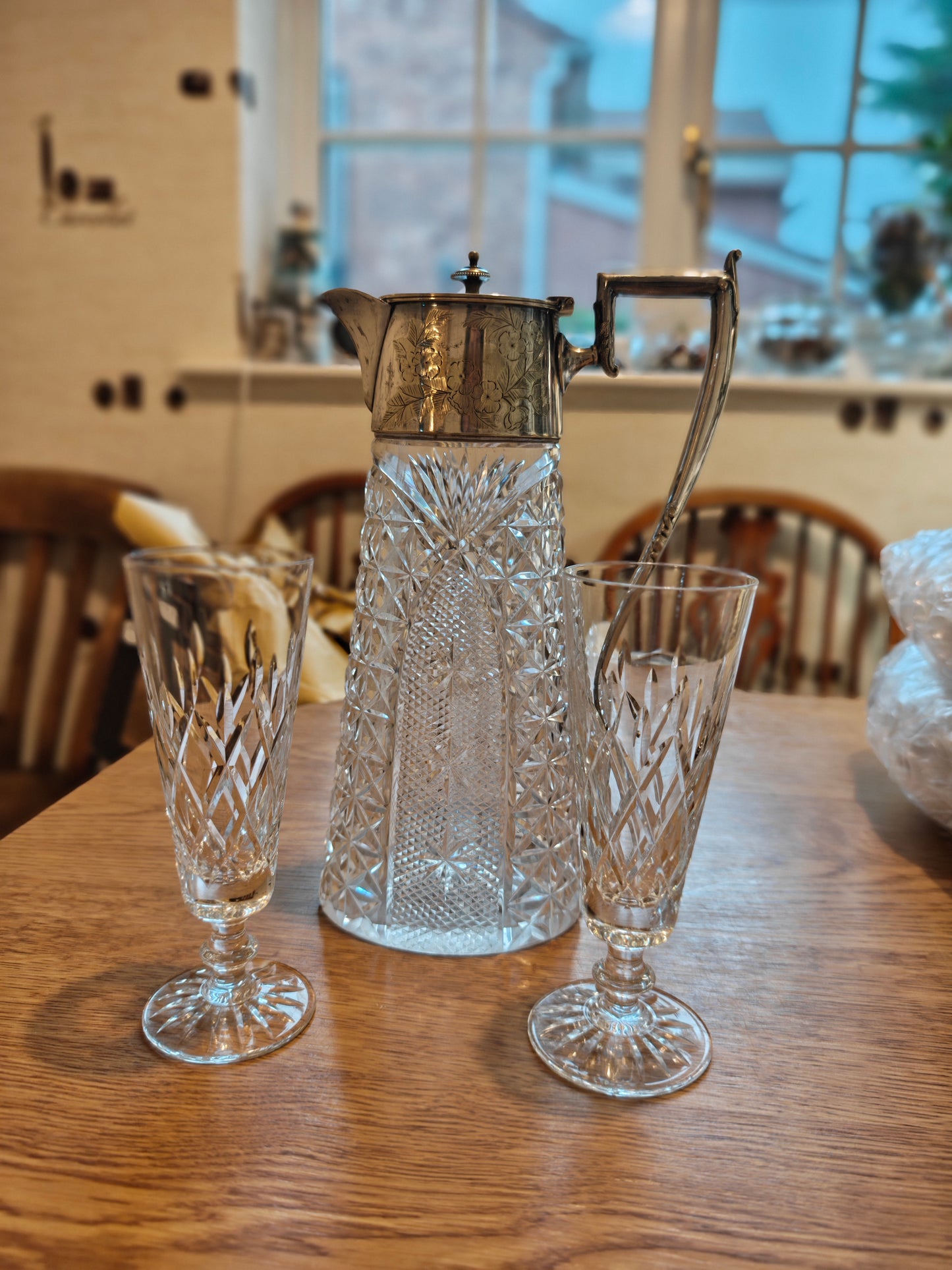 Edwardian pitcher with silver plated handle and lid. Pair with a pair of Waterford crystal glass on stem feet