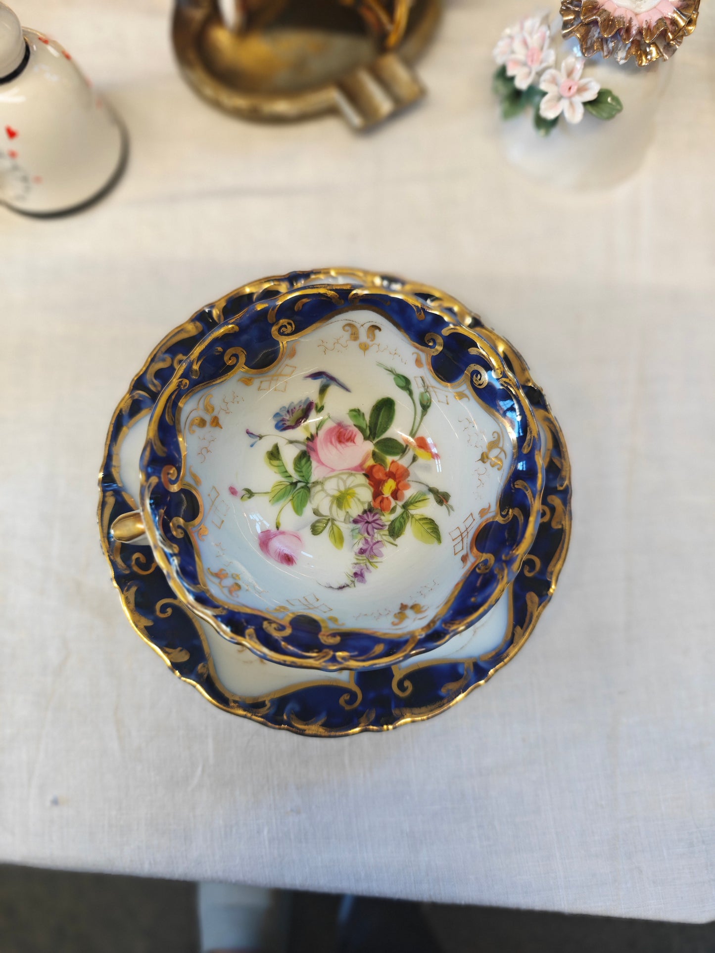 French Antique porcelain cup and saucer in rocaille style