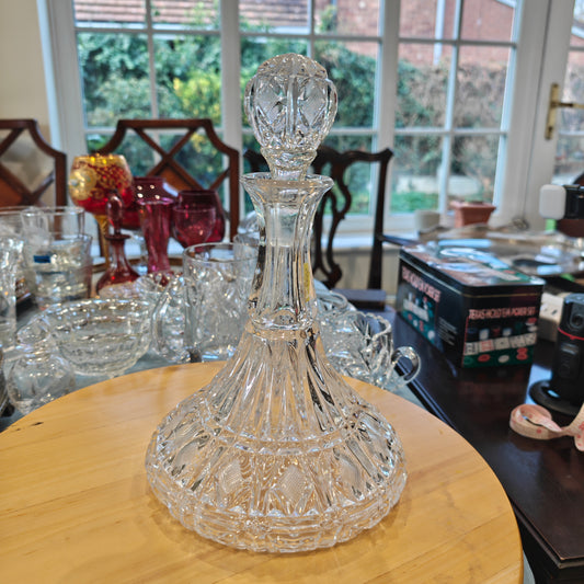 Vintage heavy pressed glass ship's decanter with a cross-hatched diamond design.