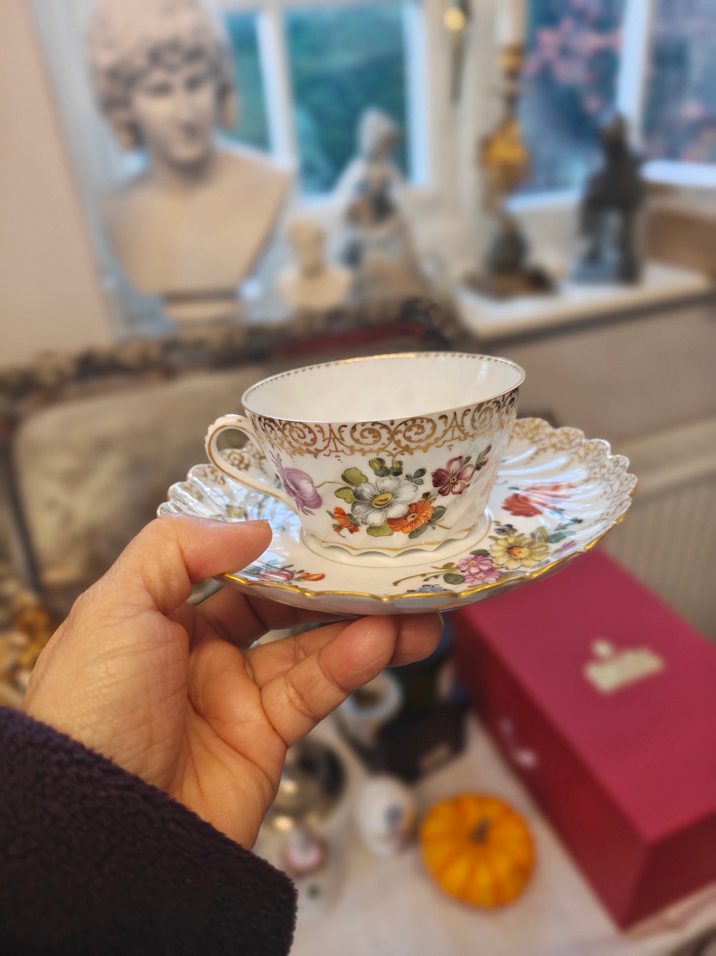 Dresden tea cup and saucer set features a delicate floral design with intricate gold accents