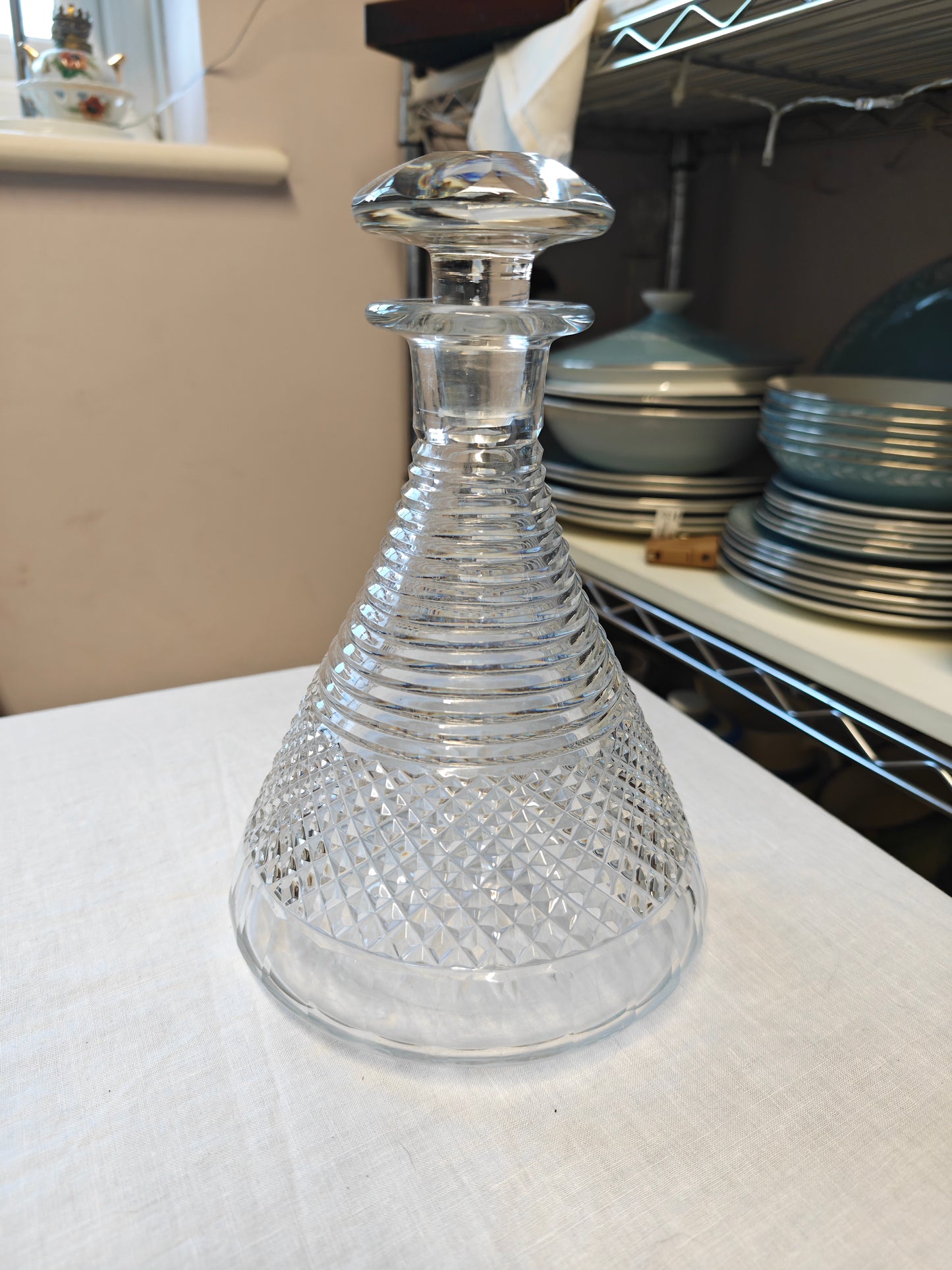 19th century crystal ships decanter with a diamond cut pattern on the base and a stepped prism design on the neck