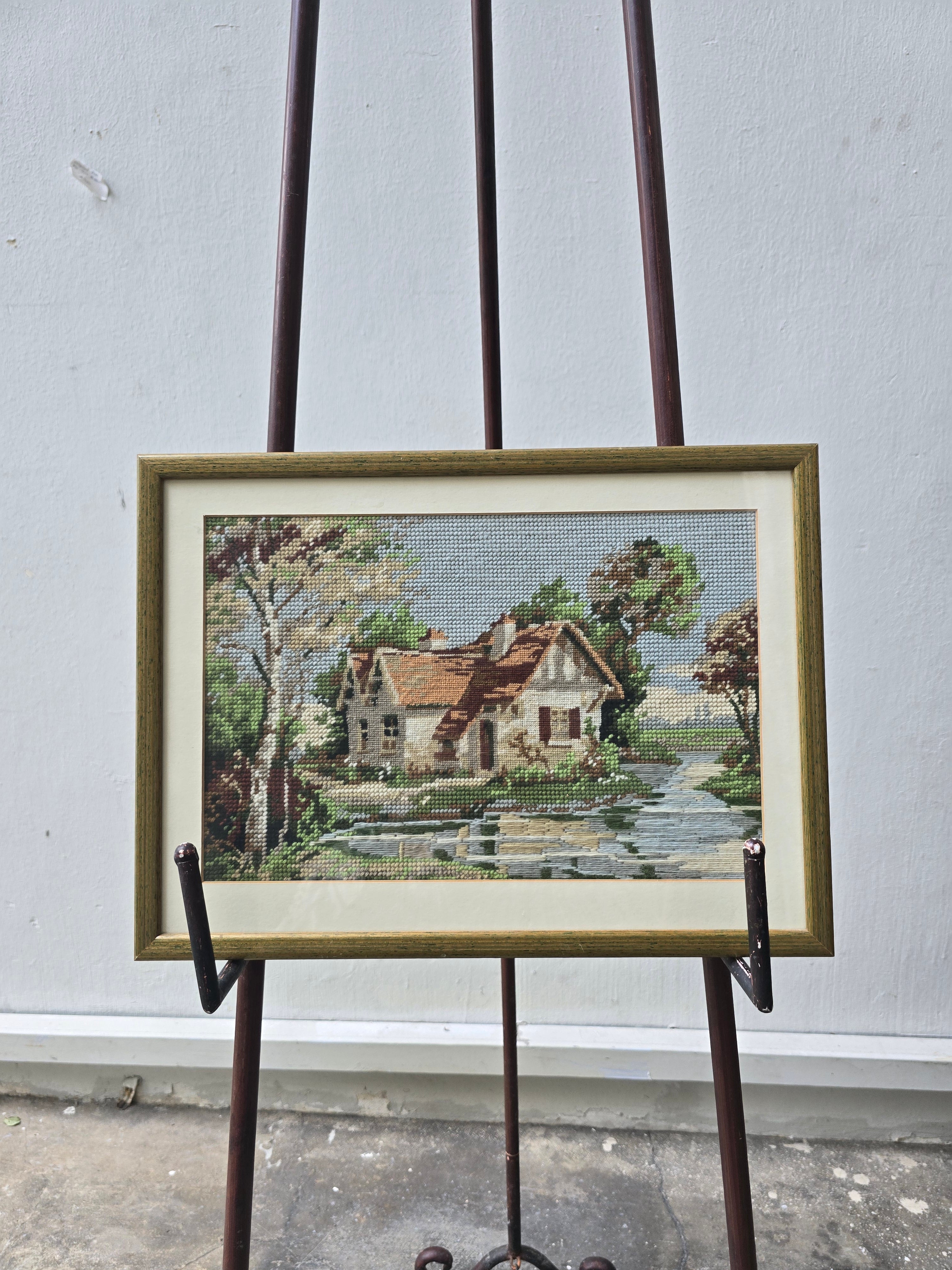 Exquisite work of needle point house on river