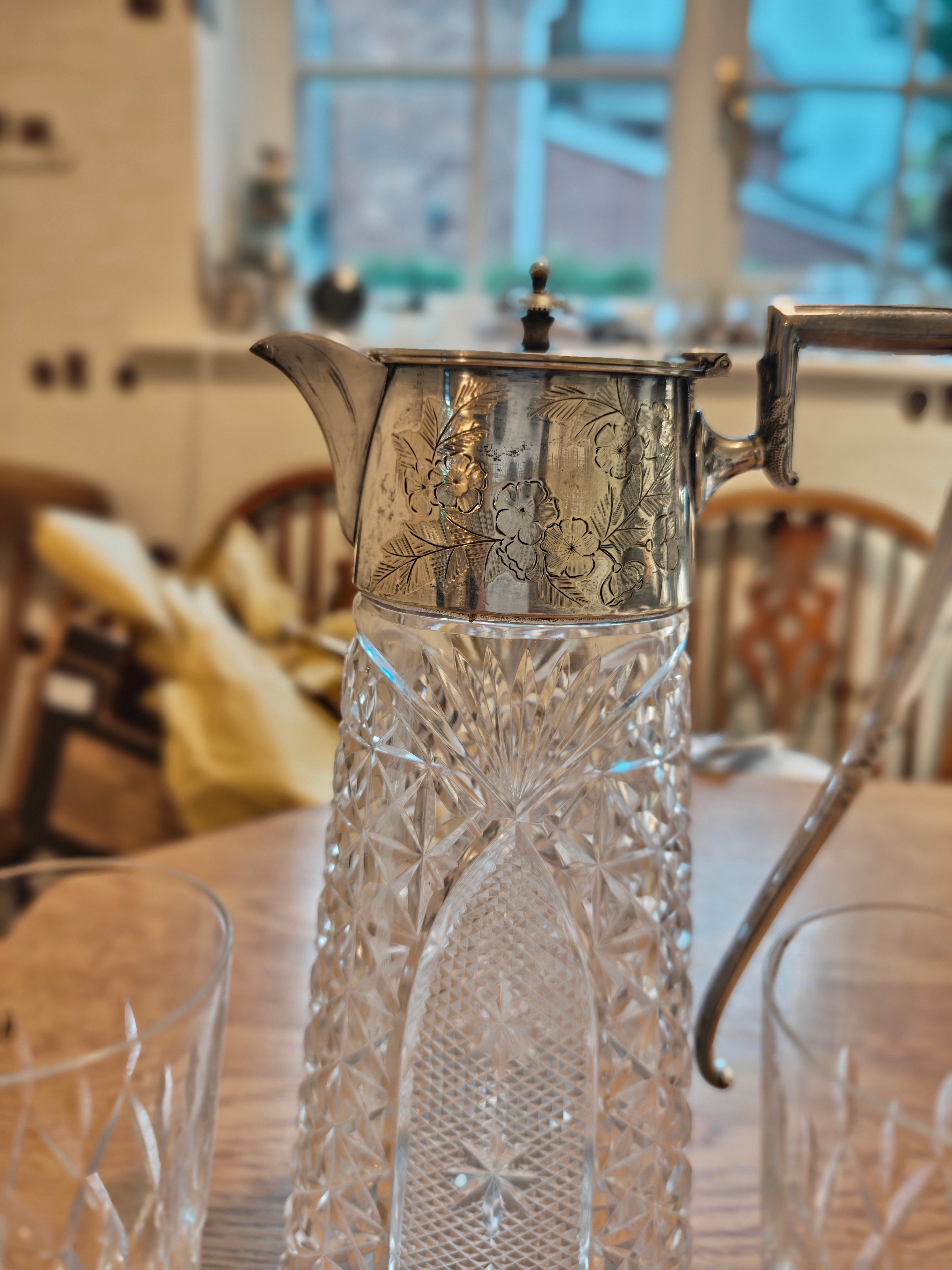 Edwardian pitcher with silver plated handle and lid. Pair with a pair of Waterford crystal glass on stem feet