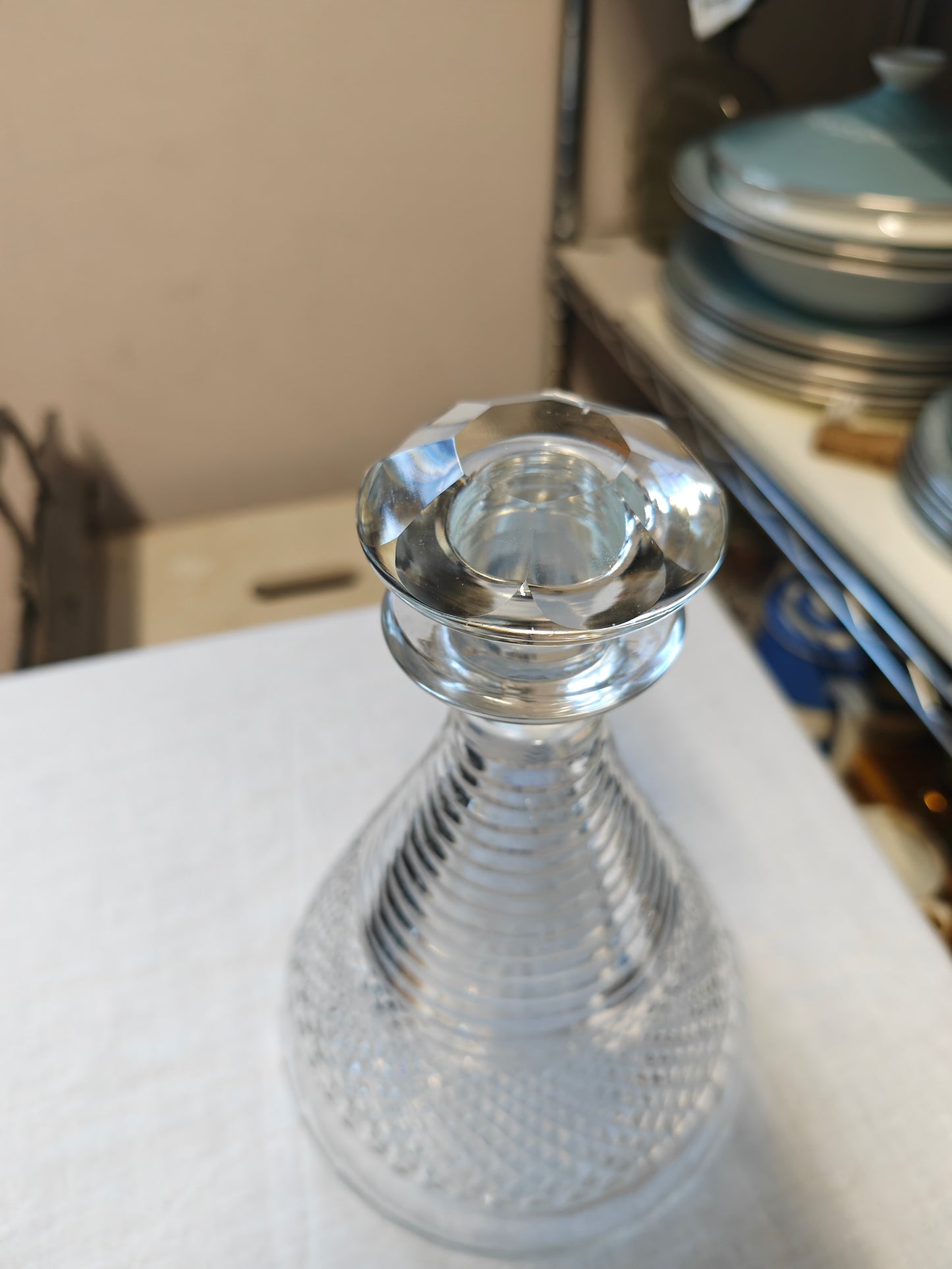 19th century crystal ships decanter with a diamond cut pattern on the base and a stepped prism design on the neck