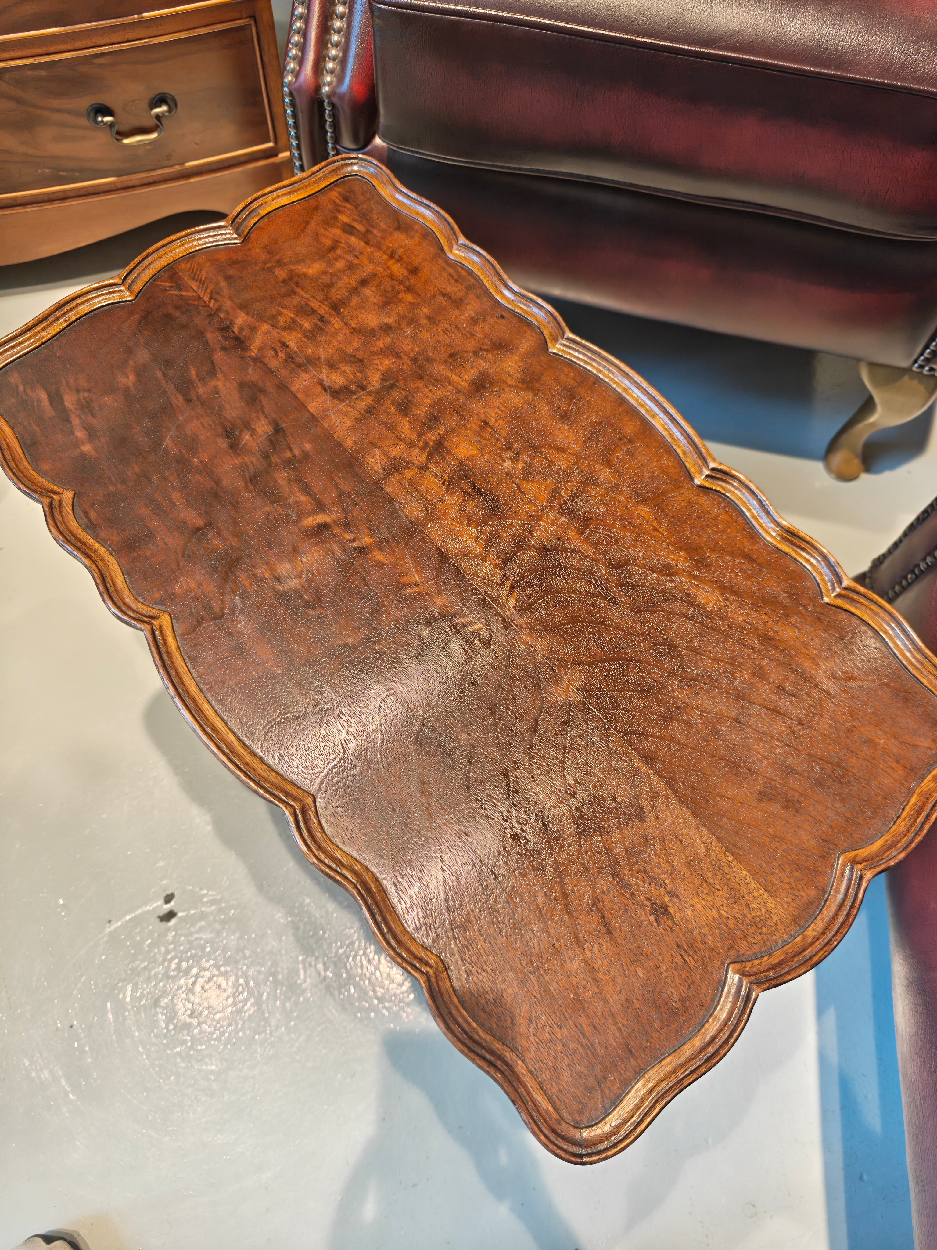 Antique mahogany table features a distinct pie-crust edge and a beautifully shaped stretchered base