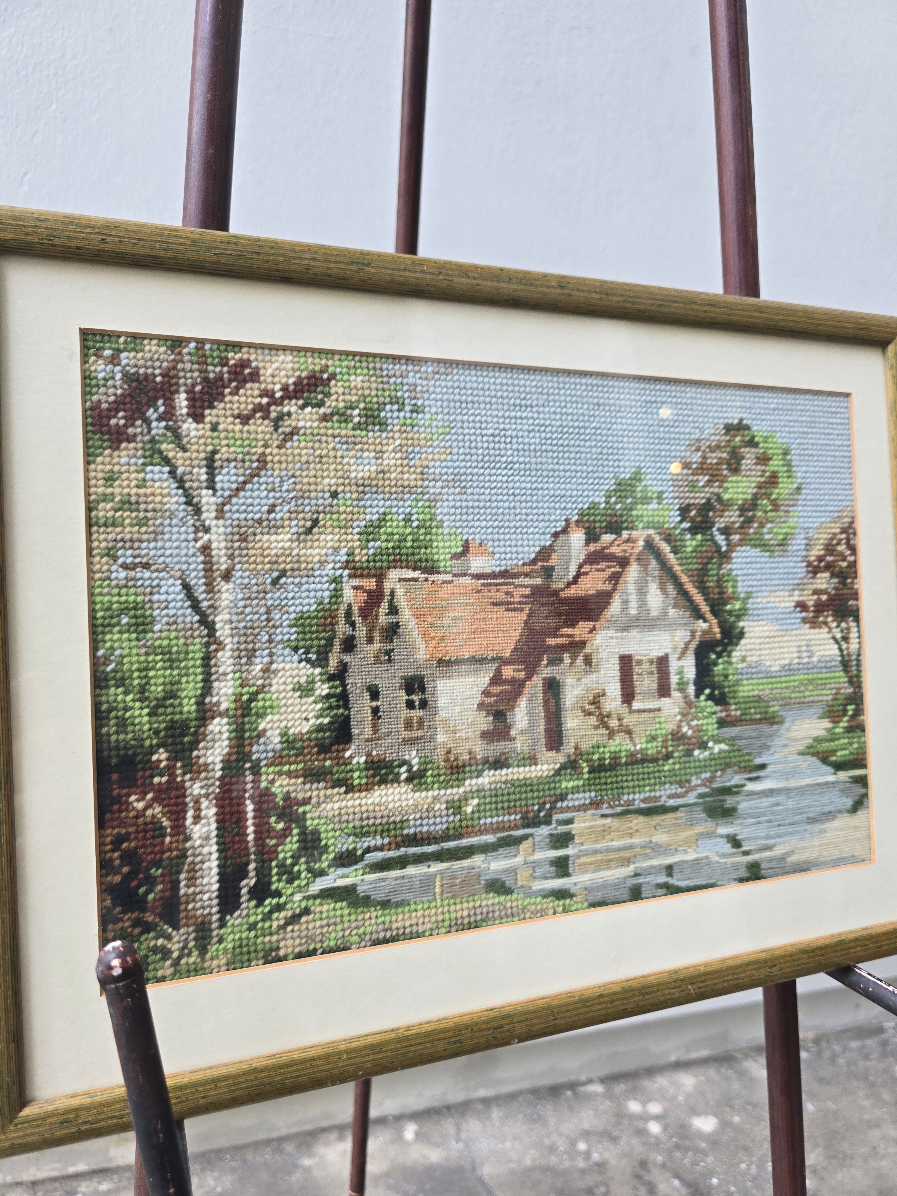 Exquisite work of needle point house on river