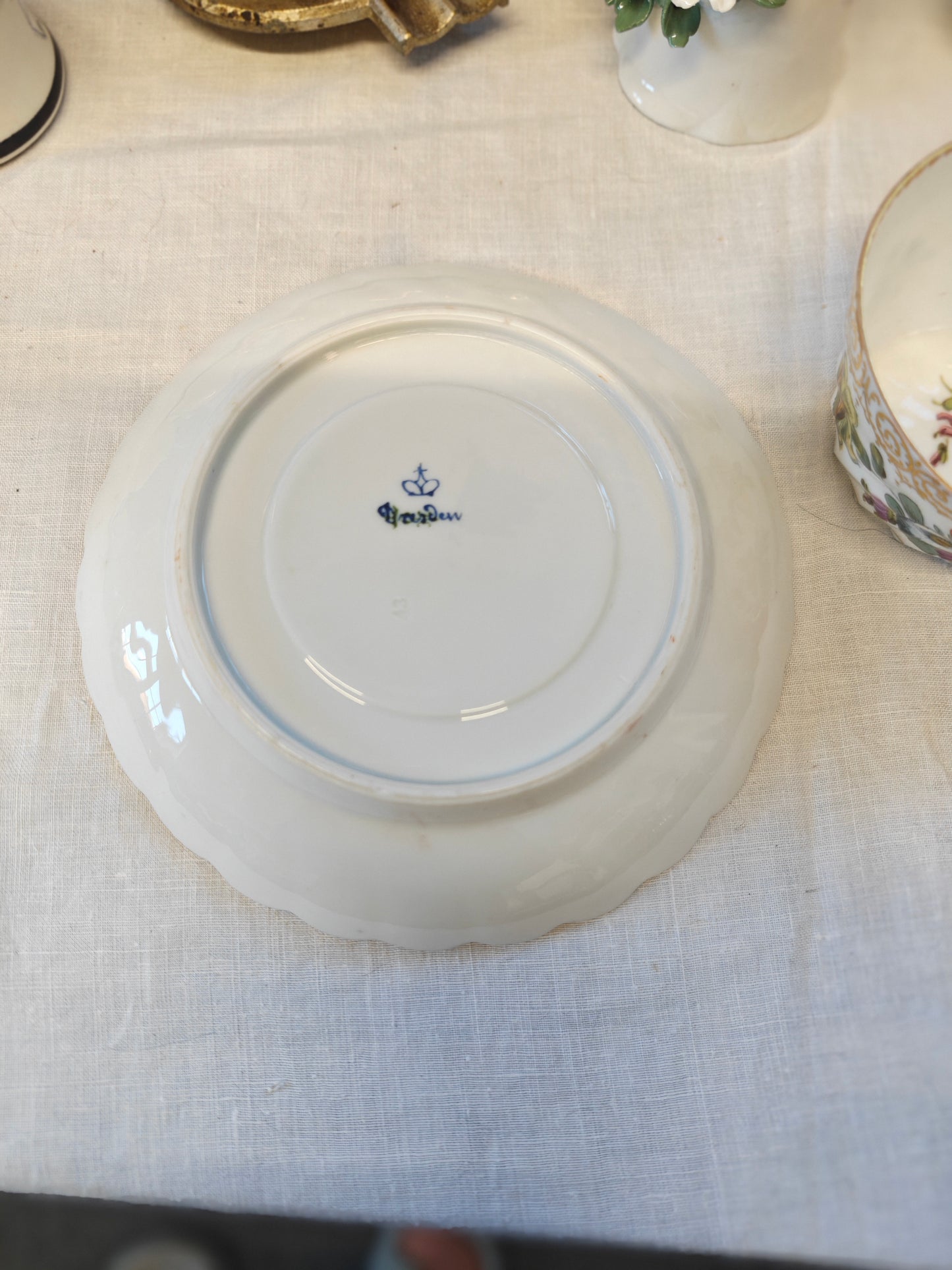 Dresden tea cup and saucer set features a delicate floral design with intricate gold accents