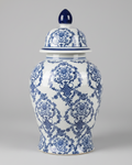 A vintage blue and white ginger jar with a floral pattern, featuring a lid with a black handle.