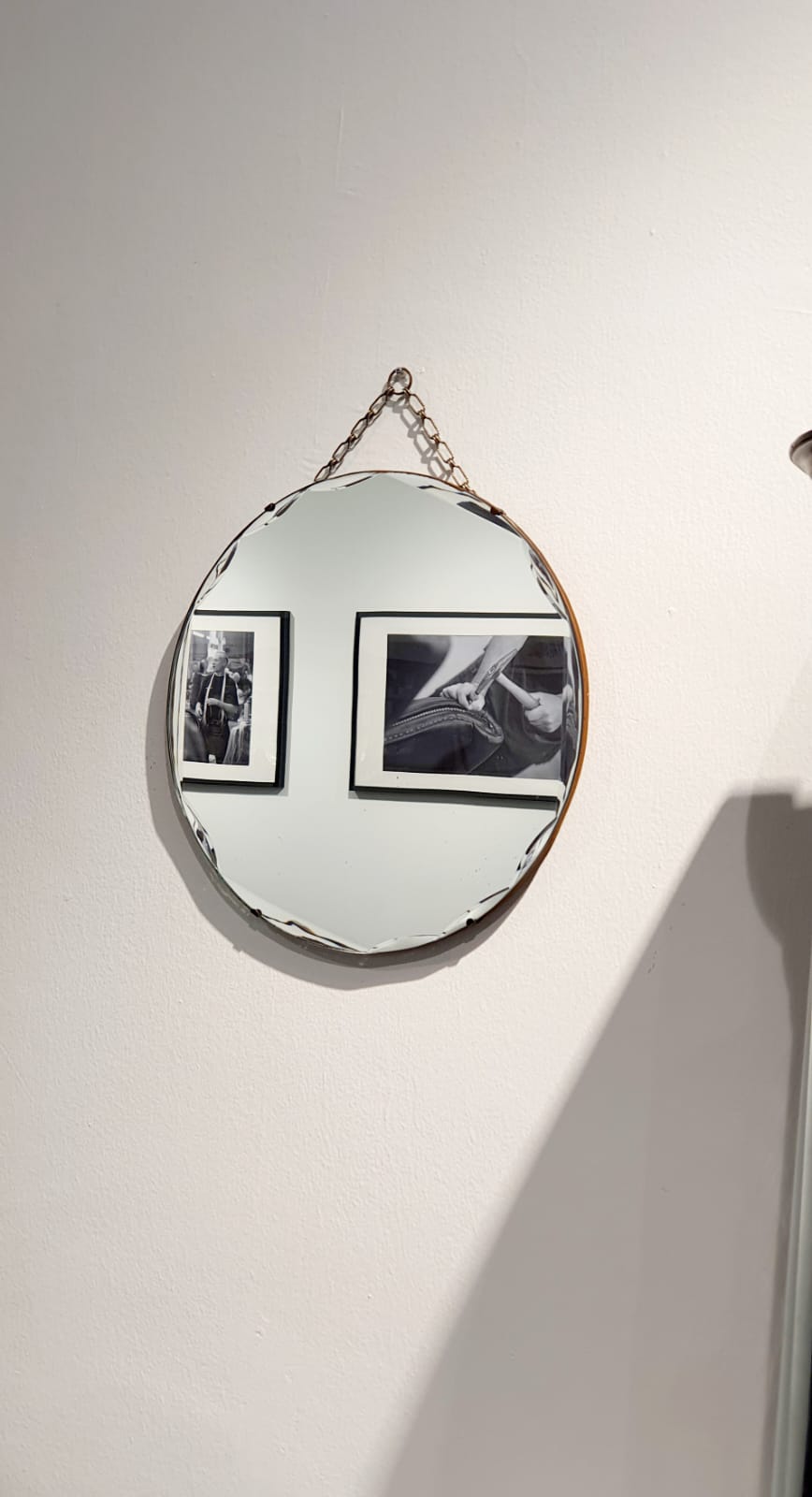 A round vintage mirror with a beveled edge